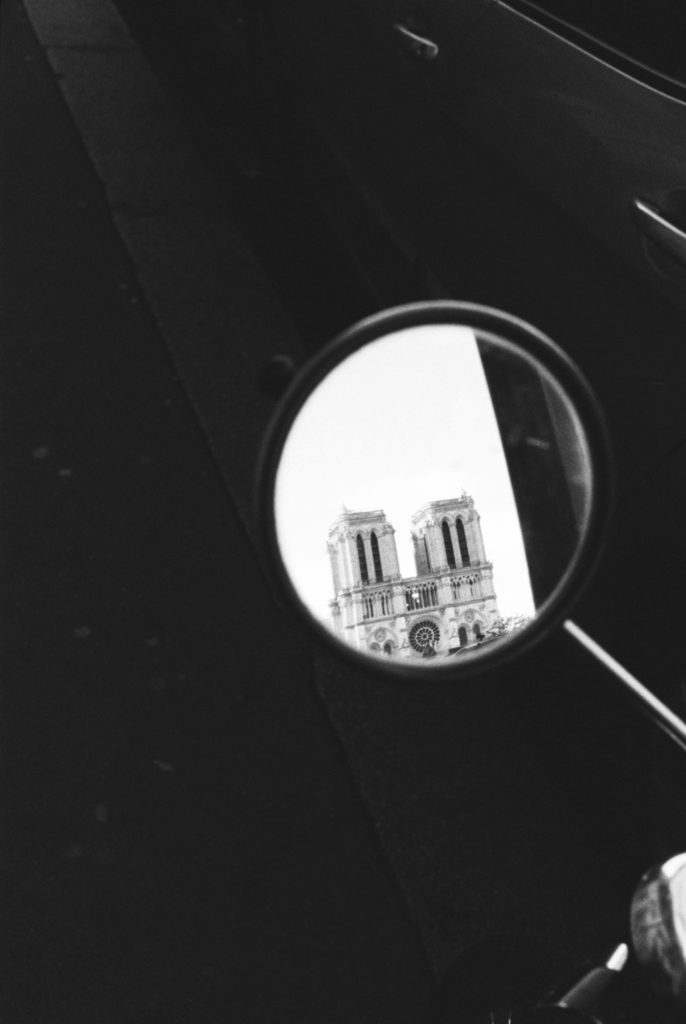 The Notre Dame's reflection from a motor scooter mirror, photographed on Pentax 35mm camera. 