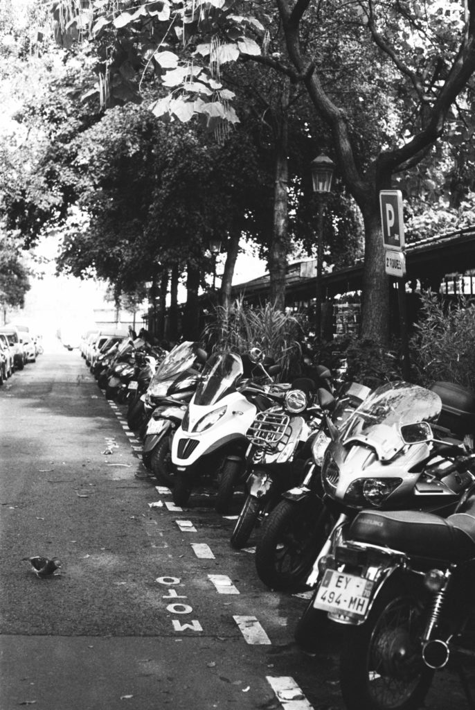 A line up of motor scooters in Paris photographed on kodak tri-x 400 and a Pentax camera. Photo by Holly Michon Photography. 
