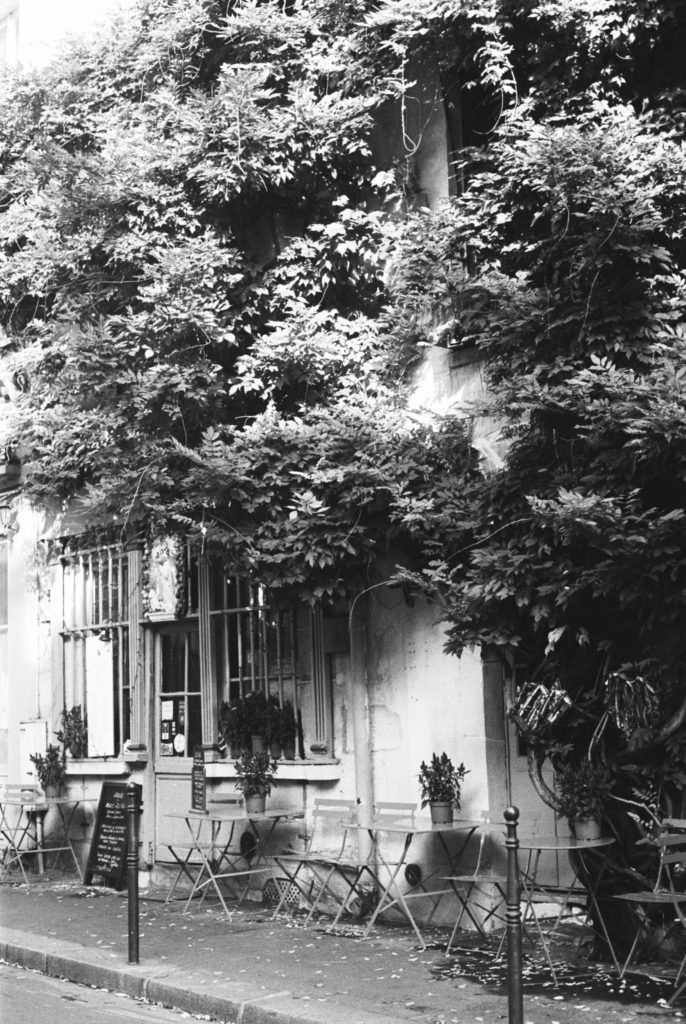 A charming, quaint cafe in Paris photographed on kodak tri-x 400 and a Pentax camera. Photo by Holly Michon Photography. 