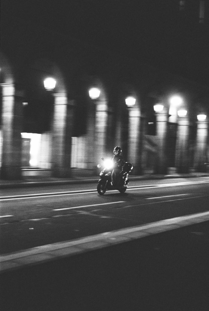 Motor scooter photographed at night outside the Louvre Museum on Kodak Tri-x 400 film on a Pentax 35mm camera. Photo by Holly Michon Photography. 