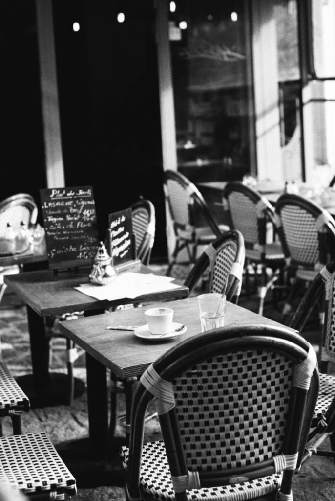 A charming, quaint cafe in Paris photographed on kodak tri-x 400 and a Pentax camera. Photo by Holly Michon Photography. 