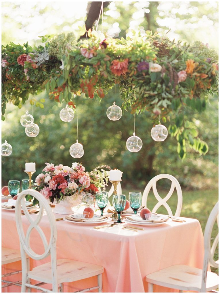 Peach, pink, and green garden themed wedding decoration of a romantic reception tablescape in Knoxville, Tennessee. Photo by Holly Michon Photography