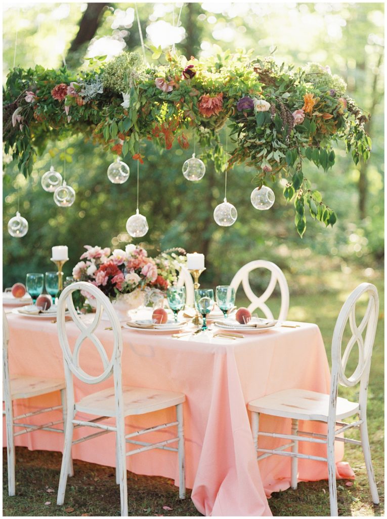 Peach, pink, and green garden themed wedding decoration of a romantic reception tablescape in Knoxville, Tennessee. Photo by Holly Michon Photography