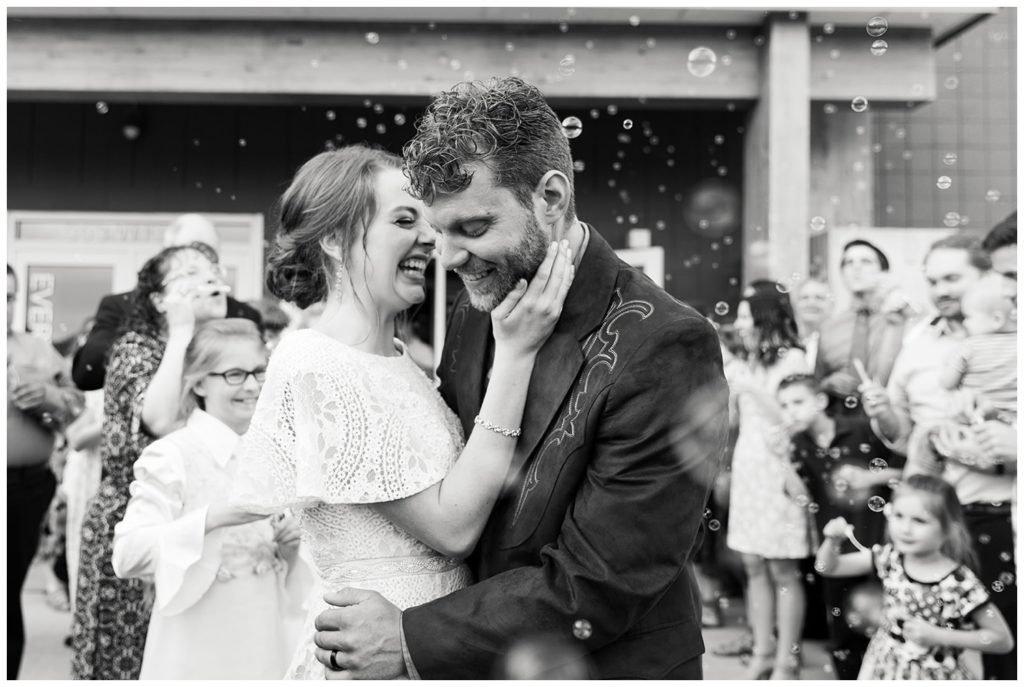 A grand bubble wedding exit in black and white - photo by Holly Michon Photography