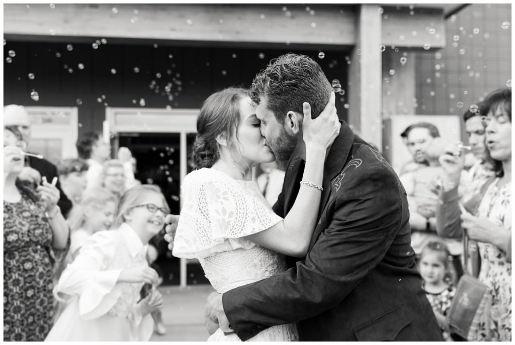 A grand bubble wedding exit in black and white - photo by Holly Michon Photography