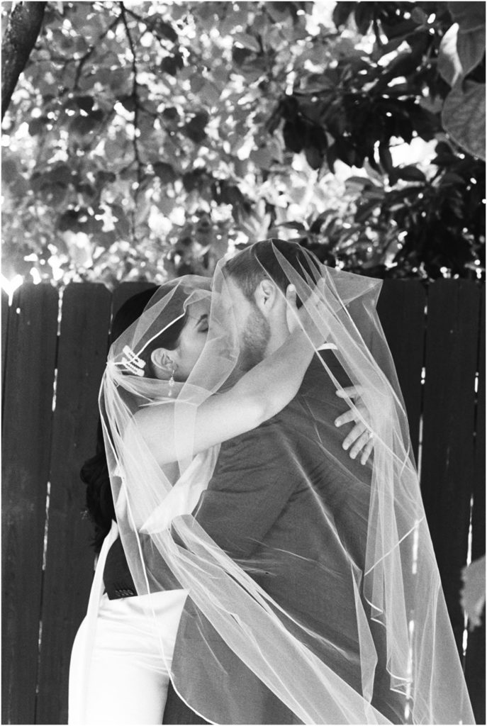 An Effortless Modern Knoxville Elopement, candid kissing veil shot