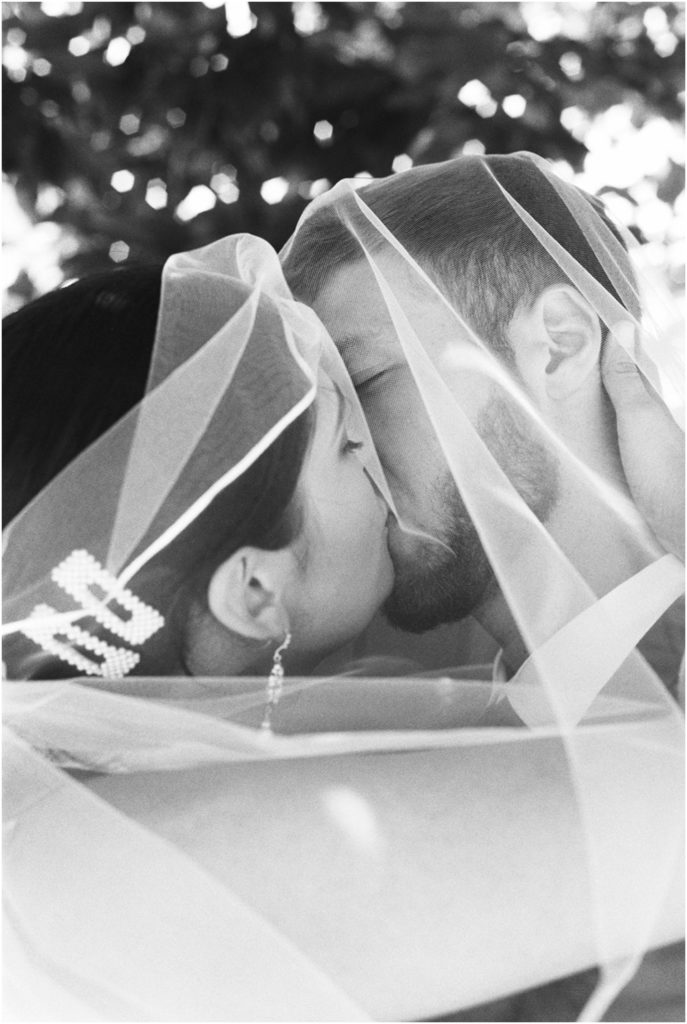 An Effortless Modern Knoxville Elopement, candid kissing veil shot