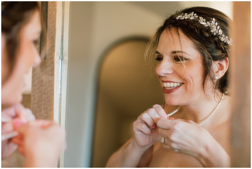 Bride getting ready in the bridal suite at Chateau Selah. Image by Holly Michon Photography.