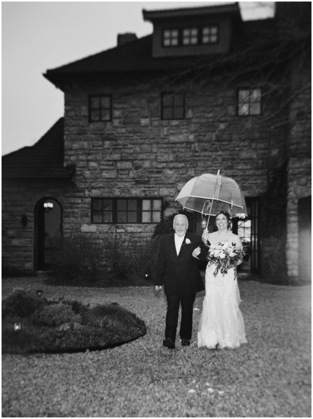 Black and white film image of a rainy wedding at Chateau Selah. Image by Holly Michon Photography.