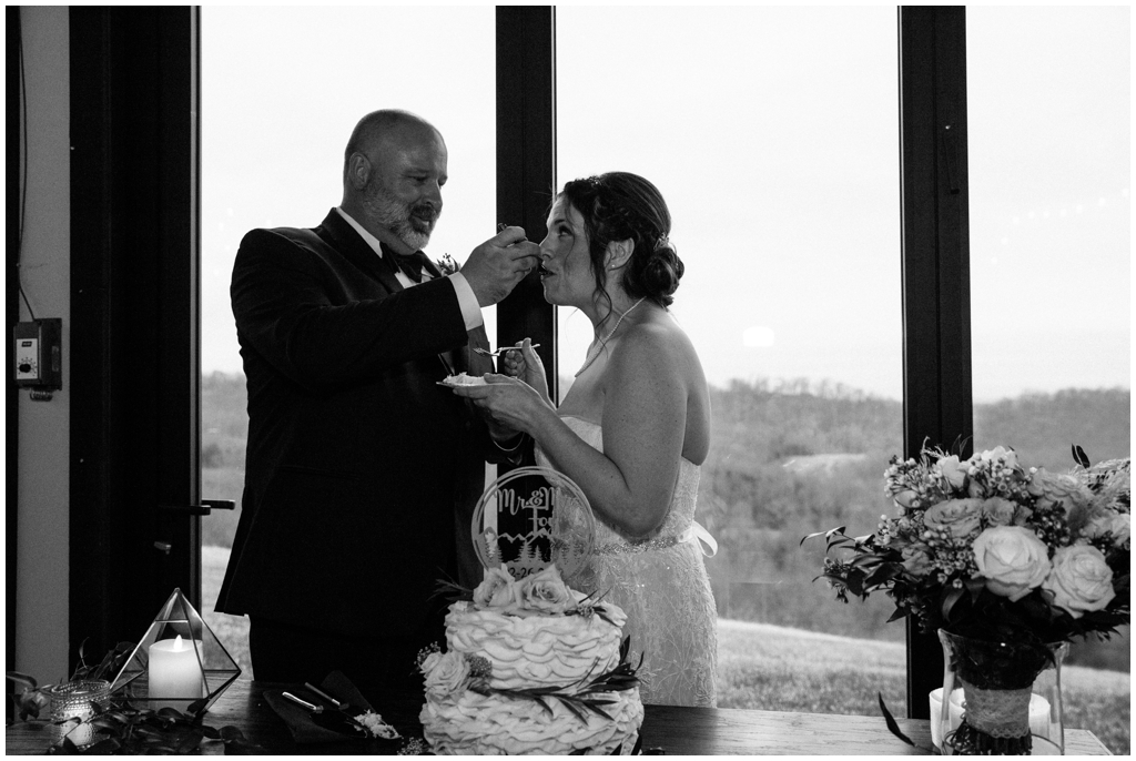 Bride & groom cut the cake and feed each other at their wedding at Chateau Selah. Image by Holly Michon Photography.