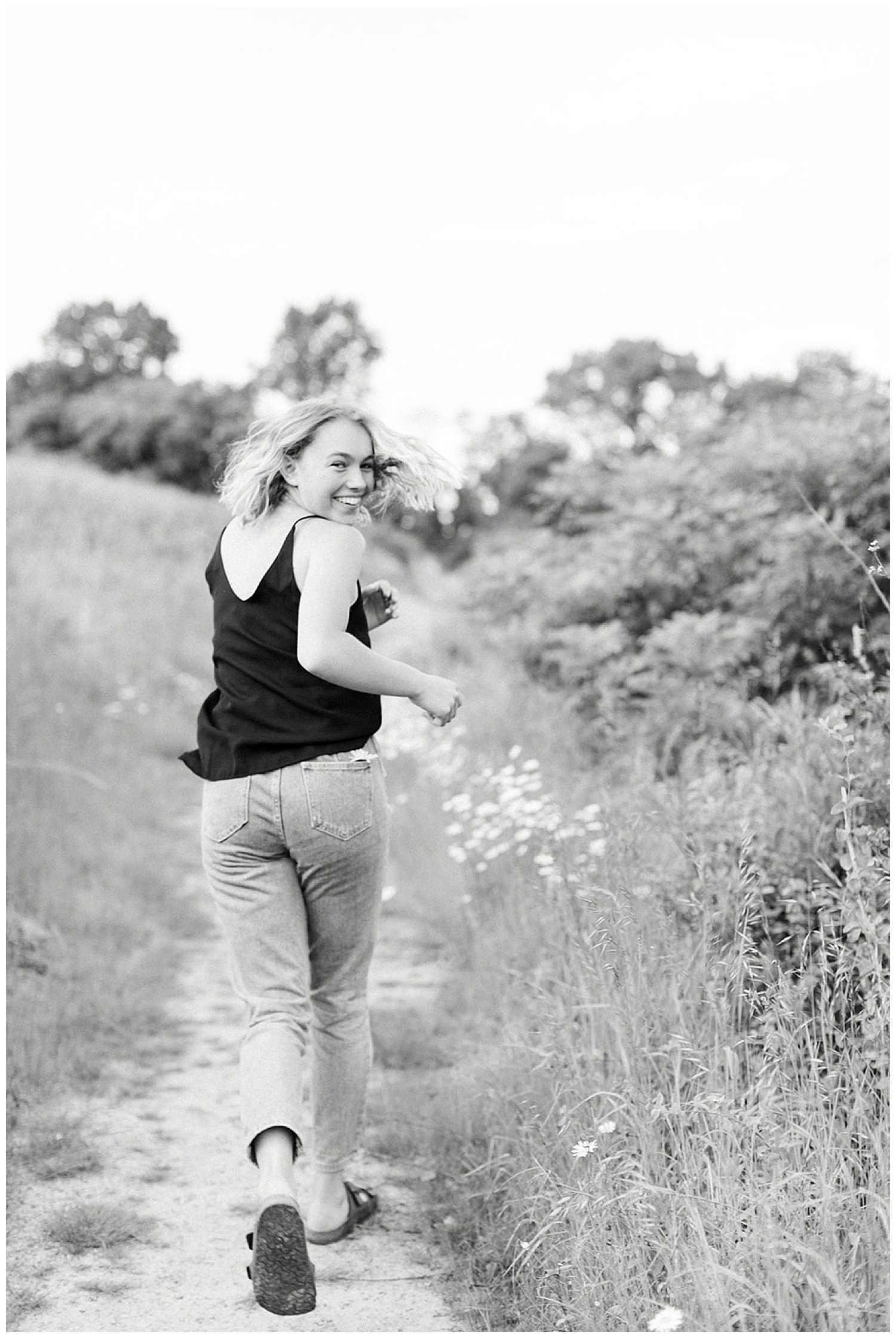 Fun Knoxville, TN high school senior session outside in natural light and meadow. Image by Holly Michon Photography
