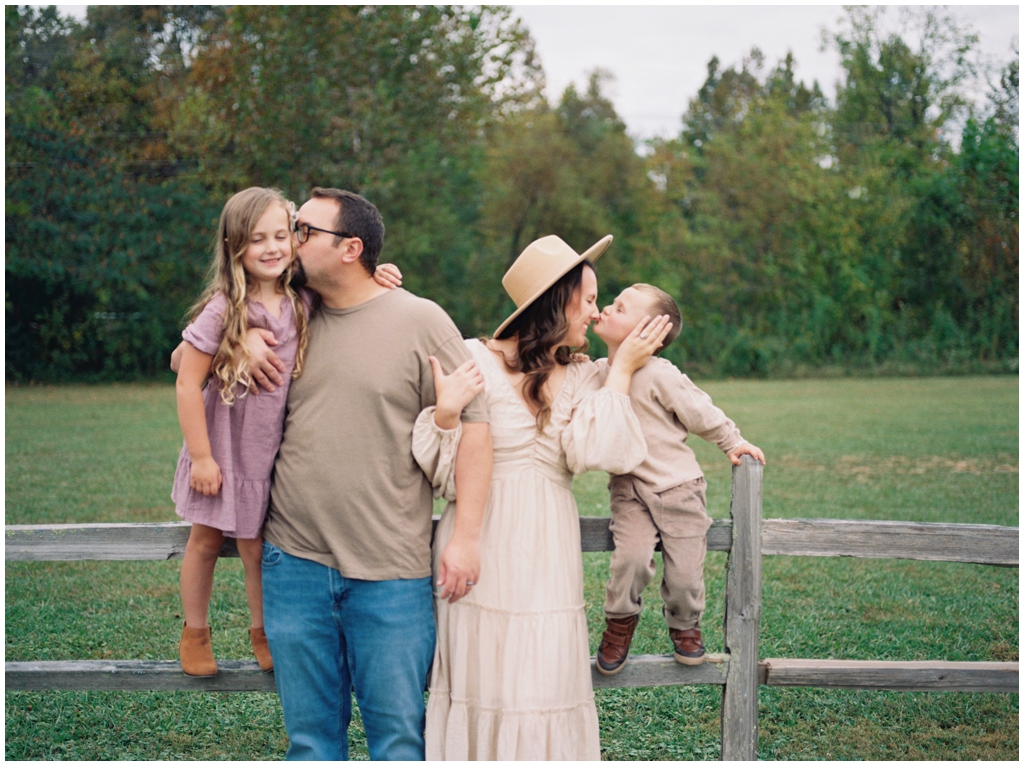 Adorable family snuggle together outdoors during their fall family session by Holly Michon Photography. 