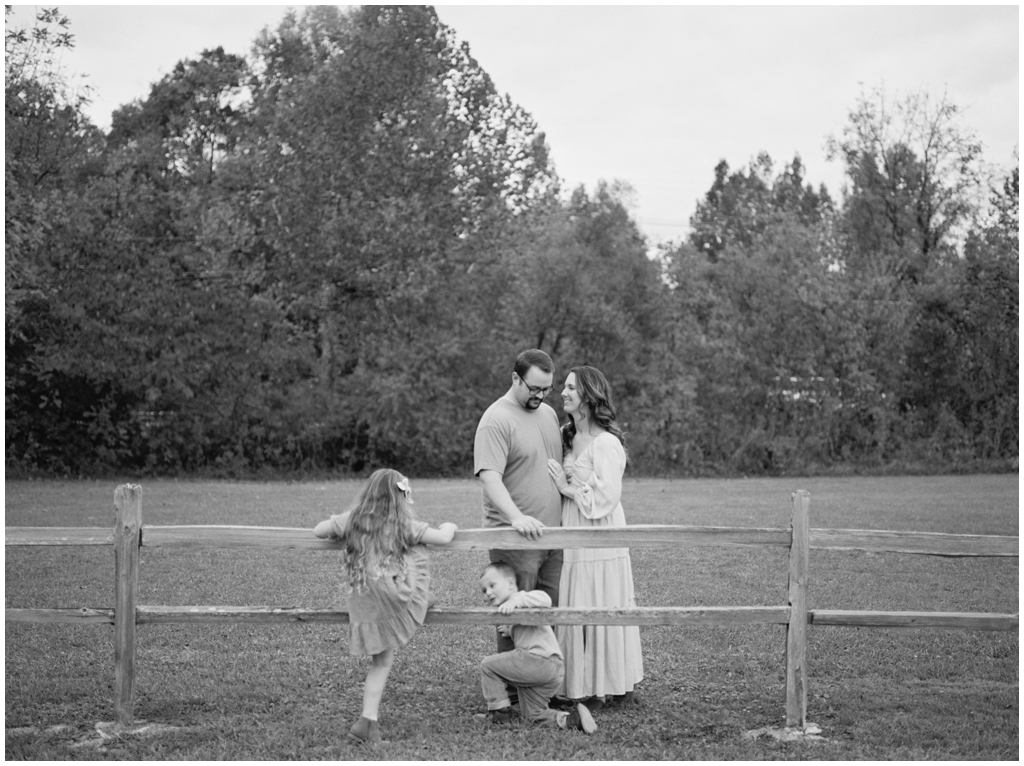 Adorable family snuggle together outdoors during their fall family session by Holly Michon Photography. 