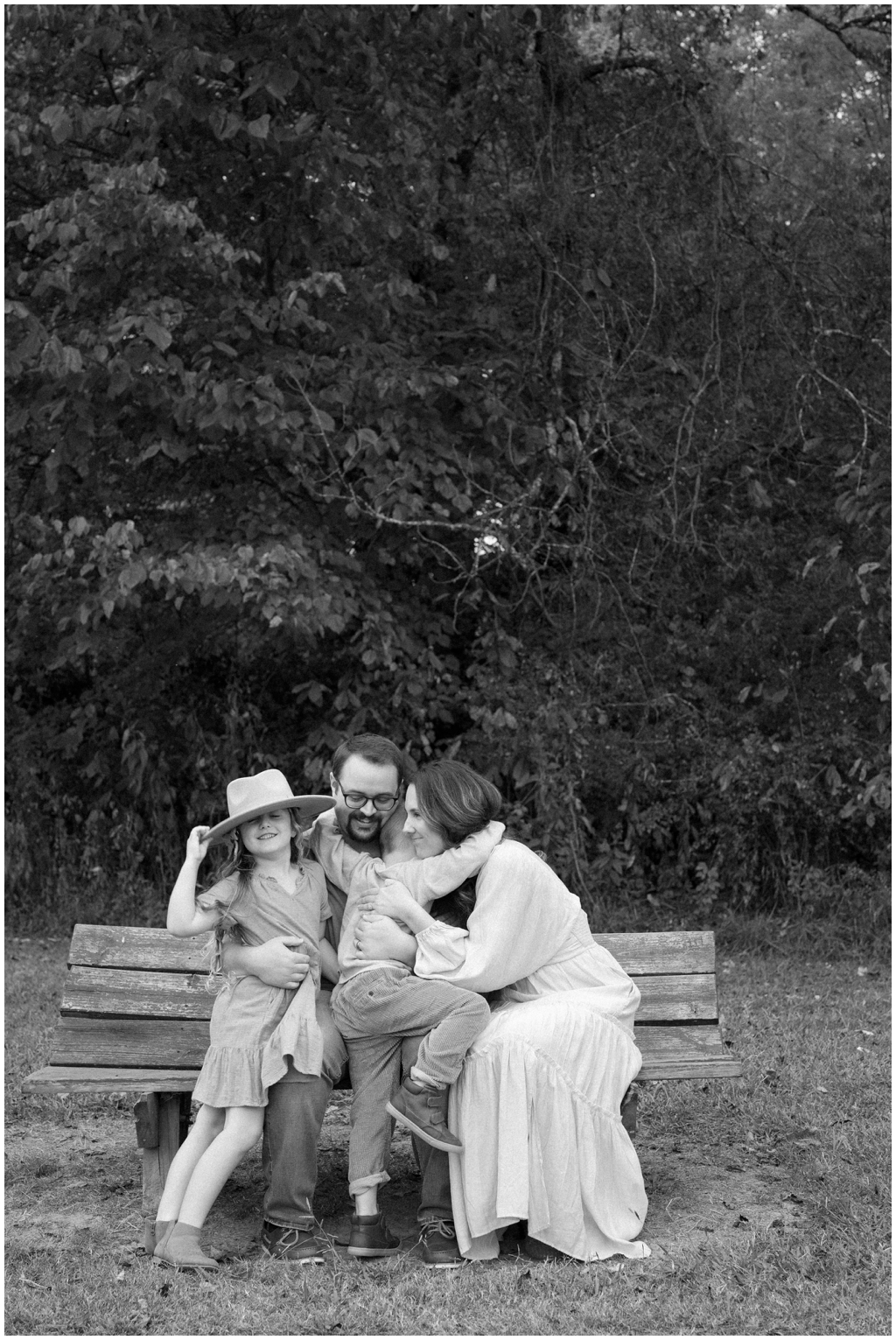 Adorable family snuggle together outdoors during their fall family session by Holly Michon Photography. 