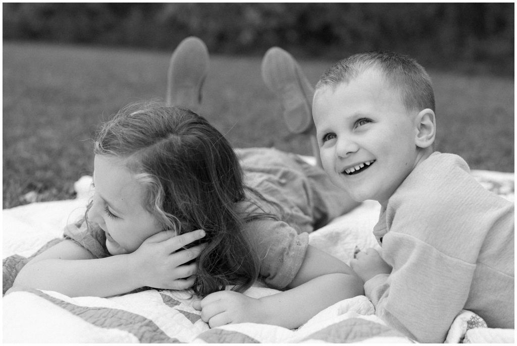 Brother and sister tease and smile fondly at each other during their family session in the fall. Knoxville, TN