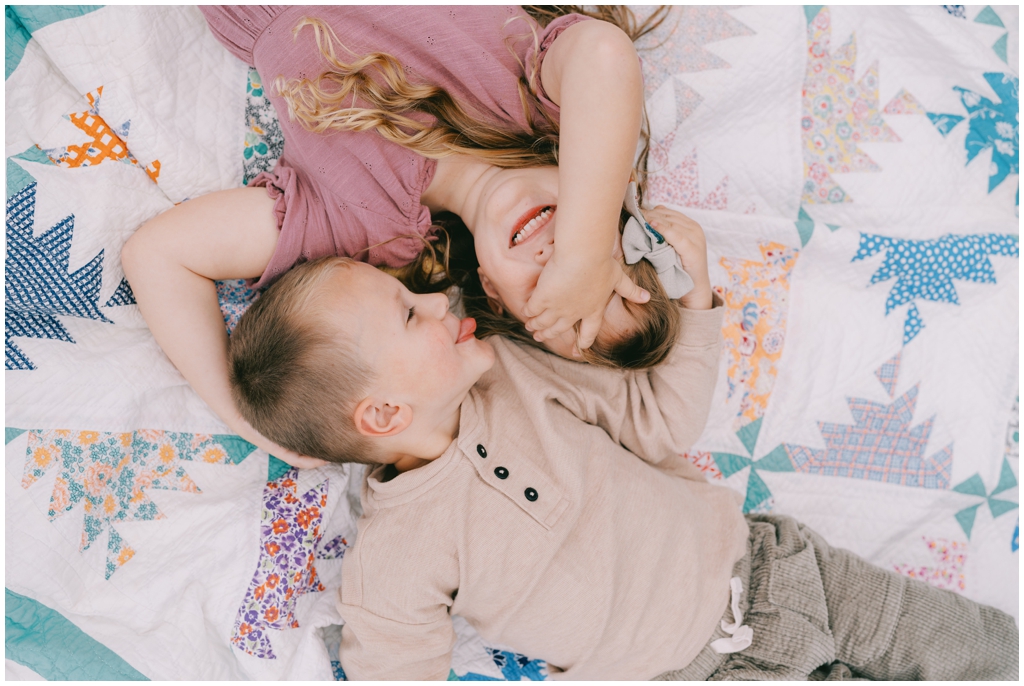 Brother and sister tease and smile fondly at each other during their family session in the fall. Knoxville, TN