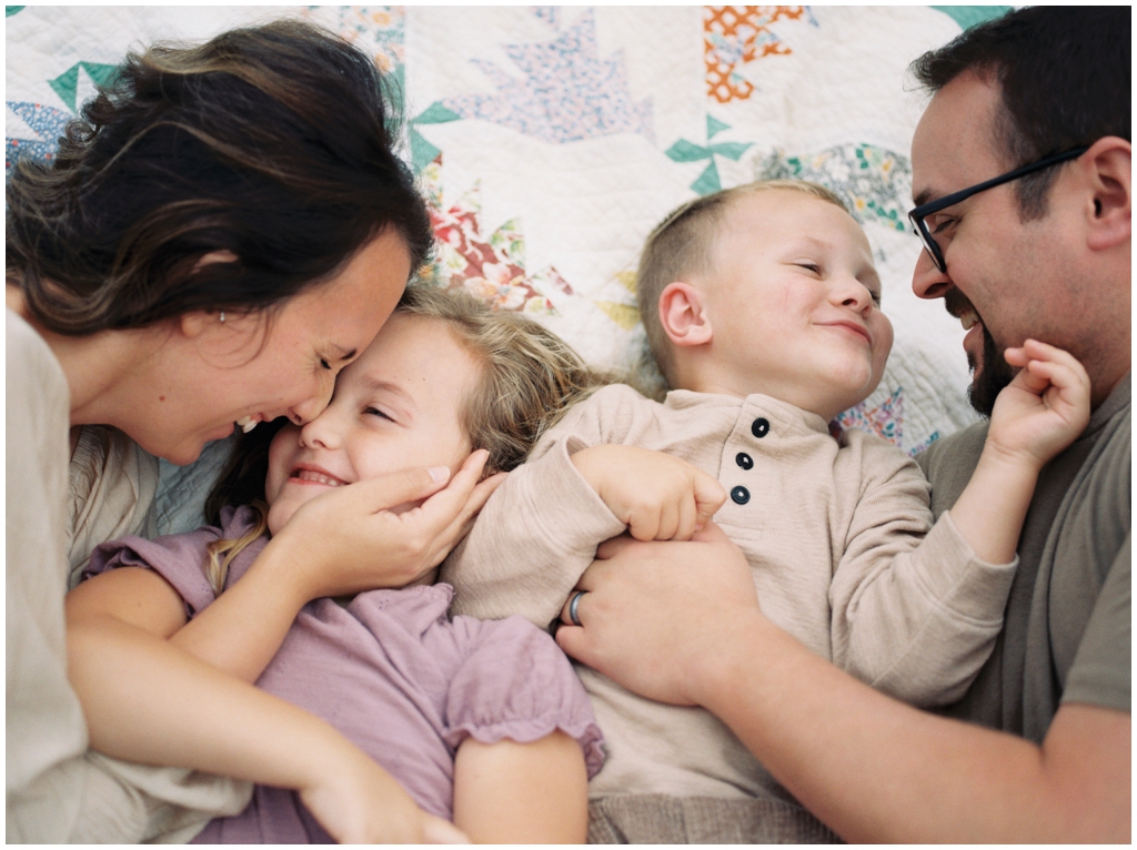 Adorable family snuggle together outdoors during their fall family session by Holly Michon Photography. 