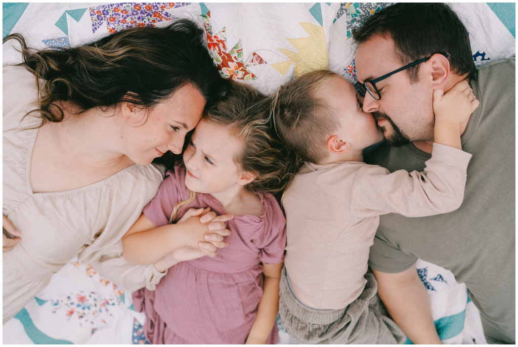 Adorable family snuggle together outdoors during their fall family session by Holly Michon Photography. 