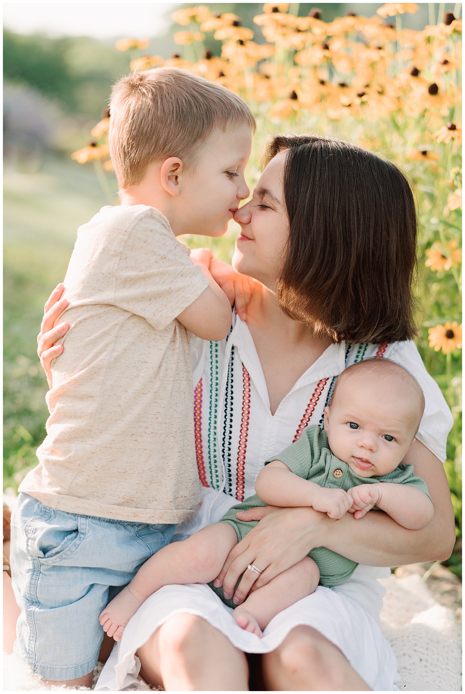 Mom and sons embrace each other in vibrant family session at UT gardens in Knoxville.