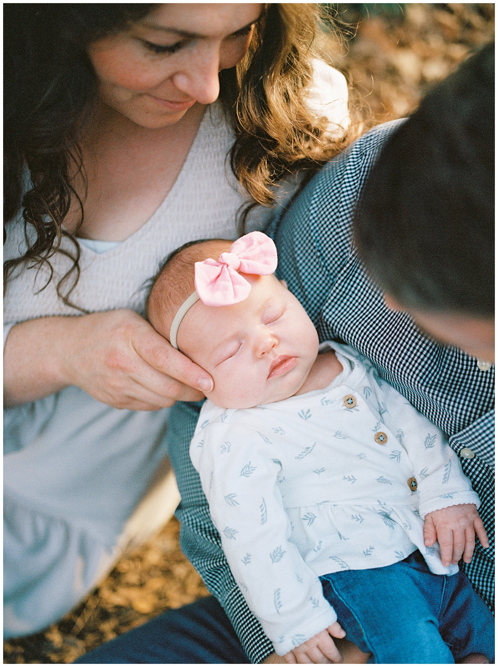 Mom and dad hold newborn in Knoxville, TN autumn photoshoot.