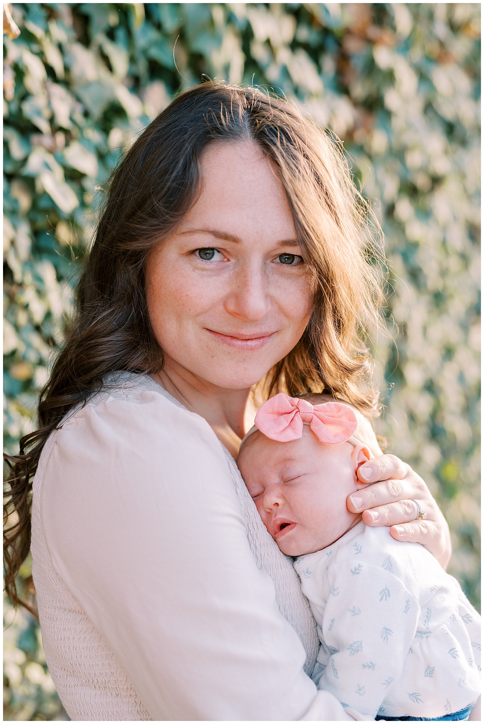 Mom holds daughter in vibrant Knoxville Botanical Gardens for photo session.