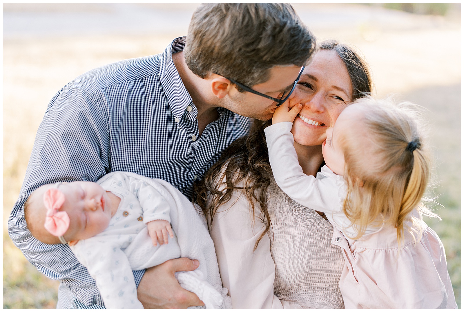 Family of four plays together in fall family photo shoot in Knoxville, TN.