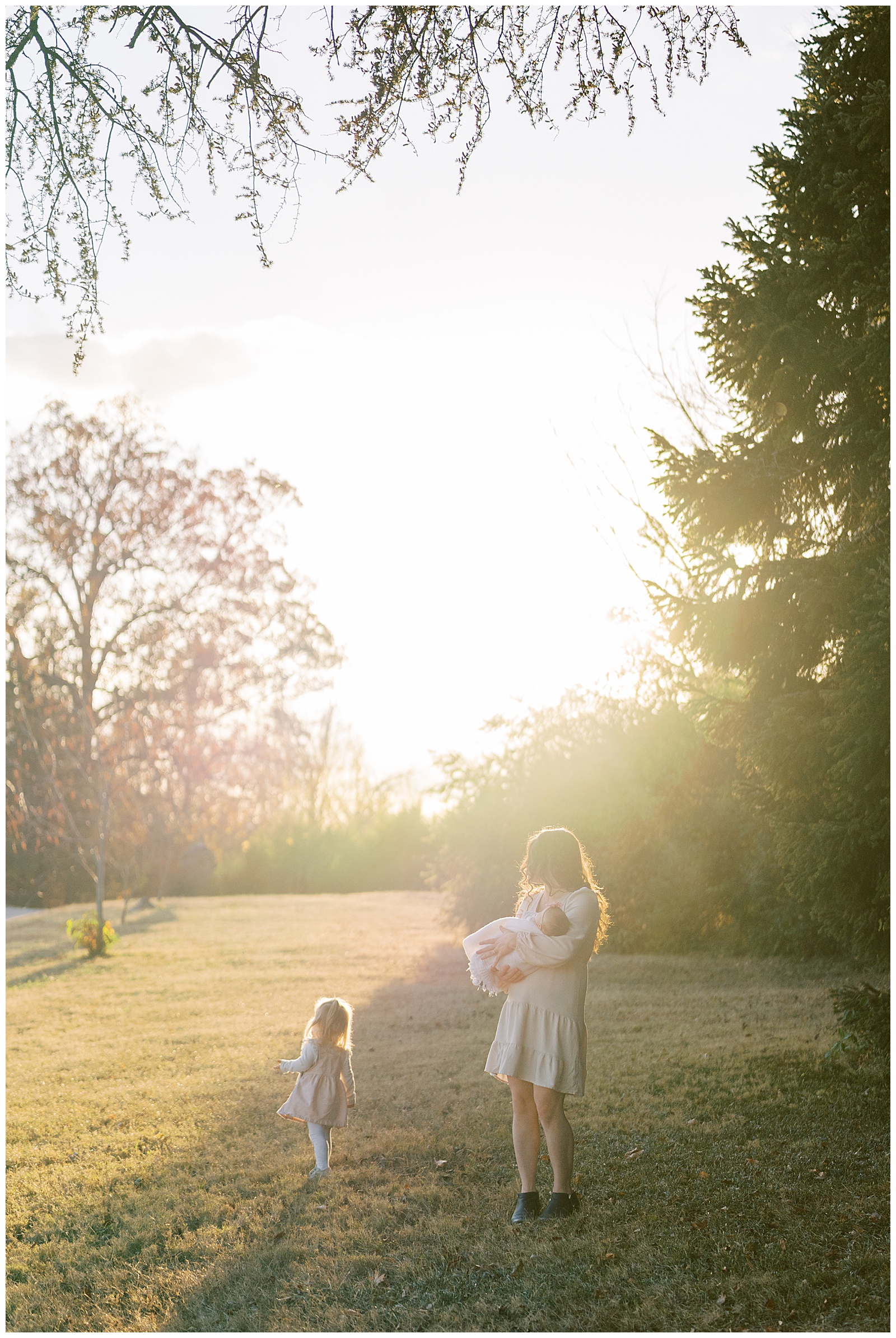 Mom and daughters stand in field during photo shoot in Knoxville, TN.