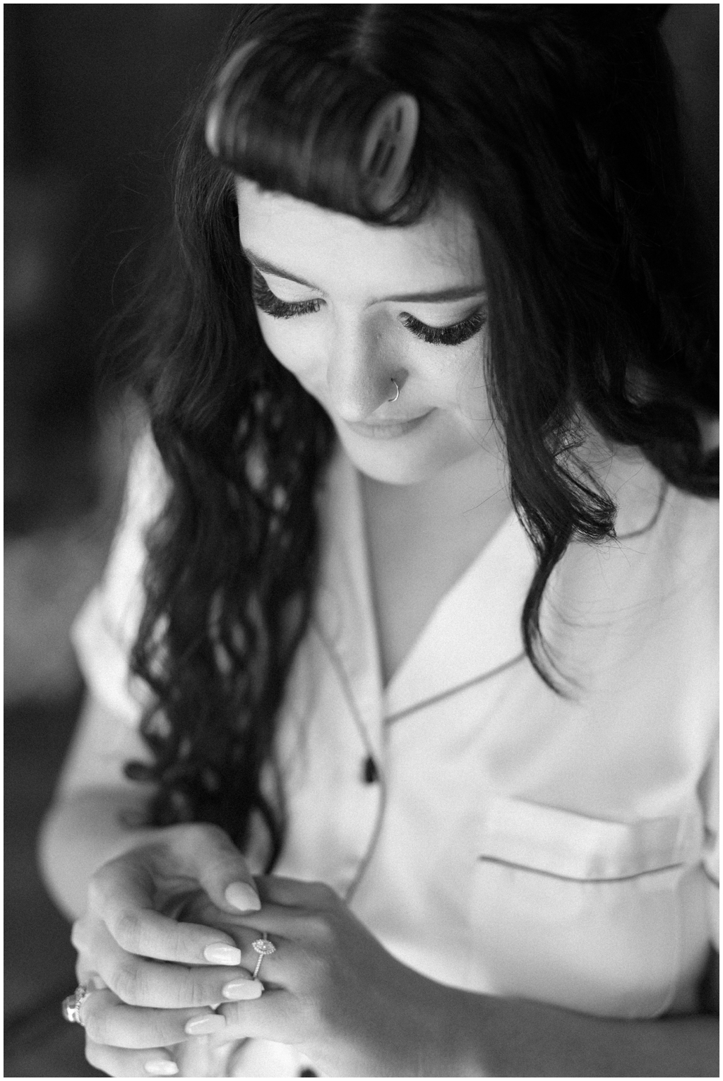 Bride getting ready while admiring ring.