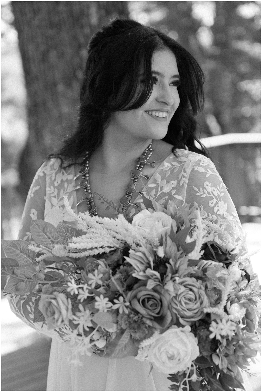 Black and white image of smiling bride solo portrait.