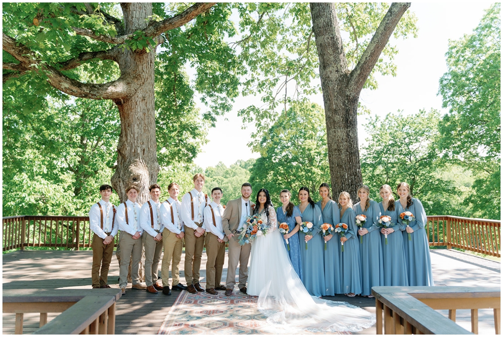 Colorful image of wedding party surrounding bride and groom for East Tennessee wedding.