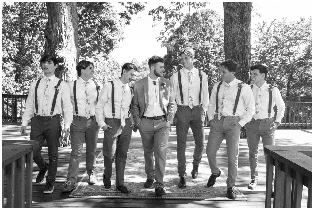 Groom walking surrounded by his groomsmen at Knoxville spring wedding.