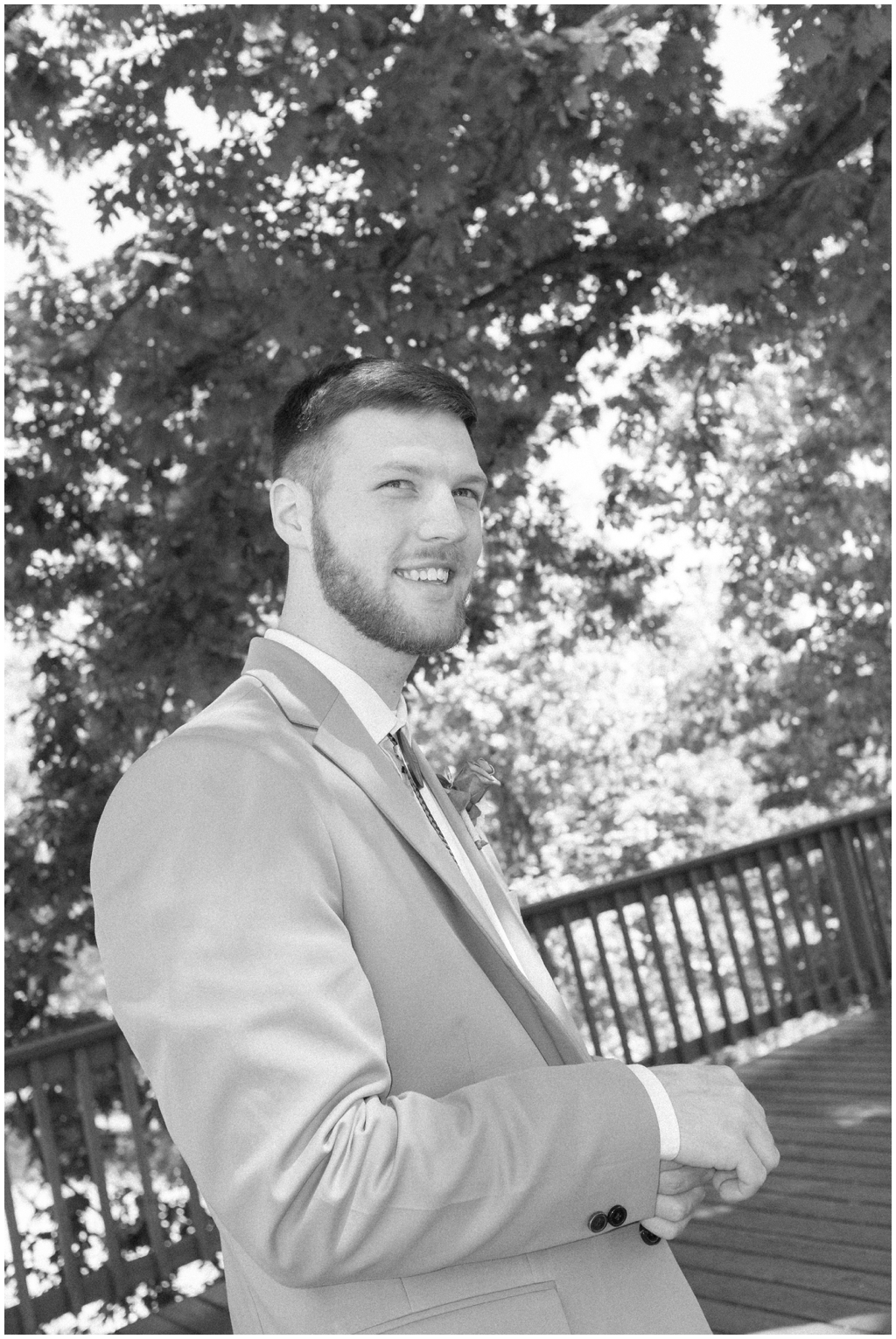 Casual black and white image of groom smiling at Knoxville spring wedding. 