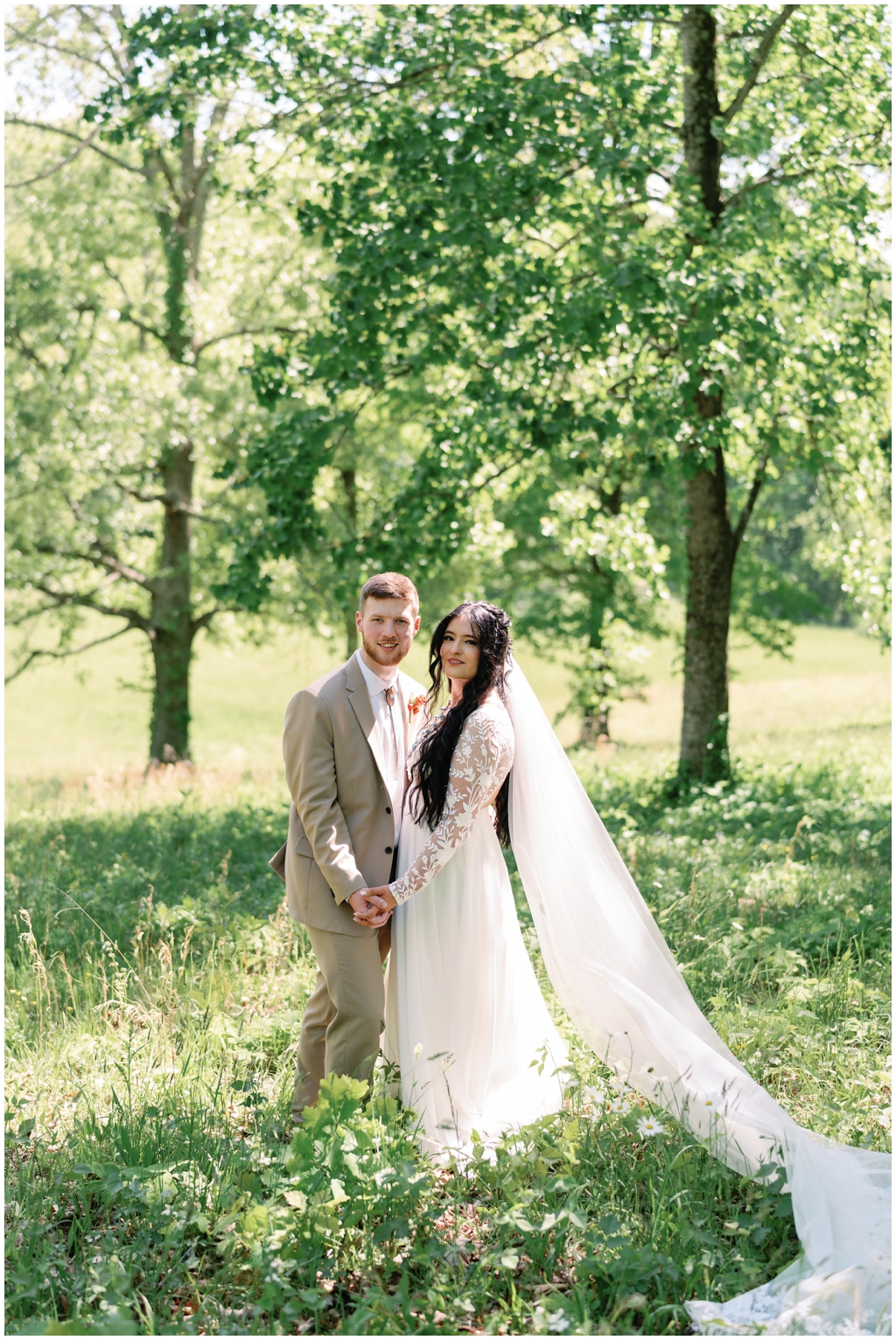 Bride and groom stun in bright image taken in a sunny meadow in East Tennessee.