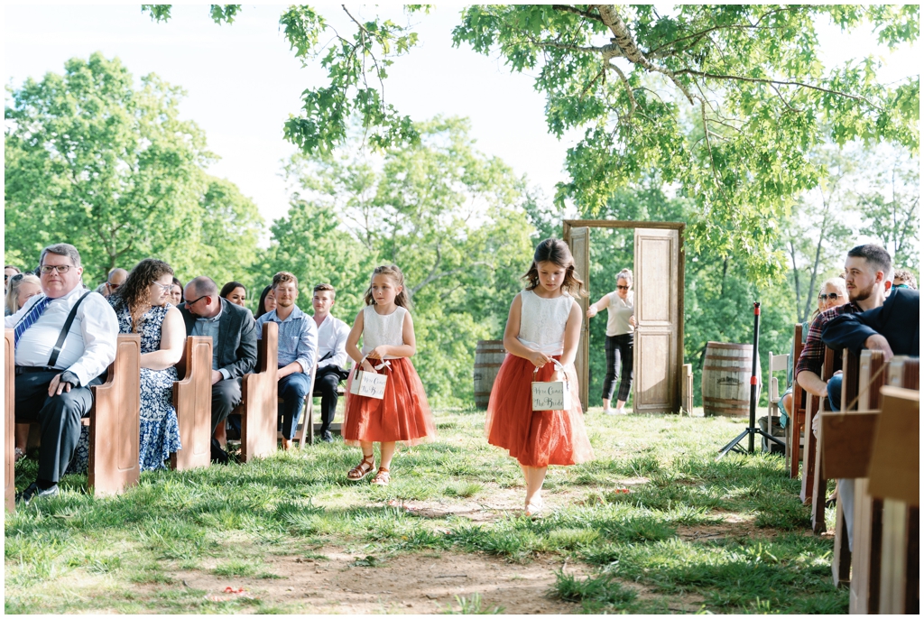 Flower girls walk down aisle at sentimental Knoxville spring wedding.