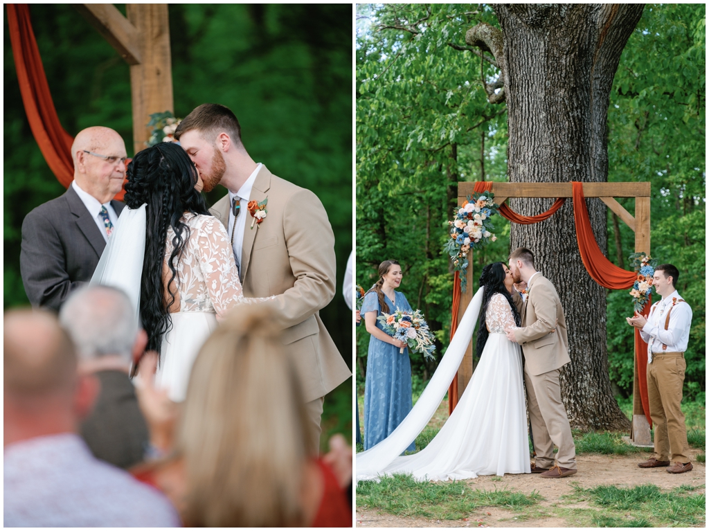 Bride and groom share kiss at the altar during ceremony of Knoxville spring wedding.