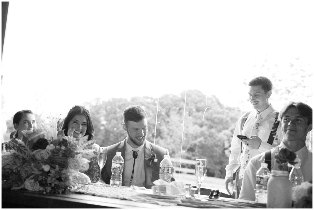 Black and white image of member of wedding party sharing speech during wedding reception at Knoxville wedding.