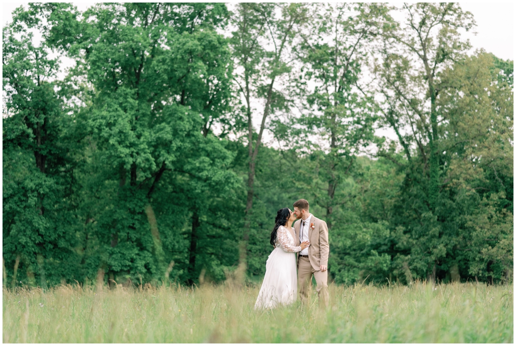 Bride and groom kiss in field in Knoxville, TN wedding.