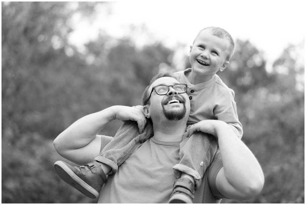 Black and white image of son and dad playing together in Knoxville, TN.