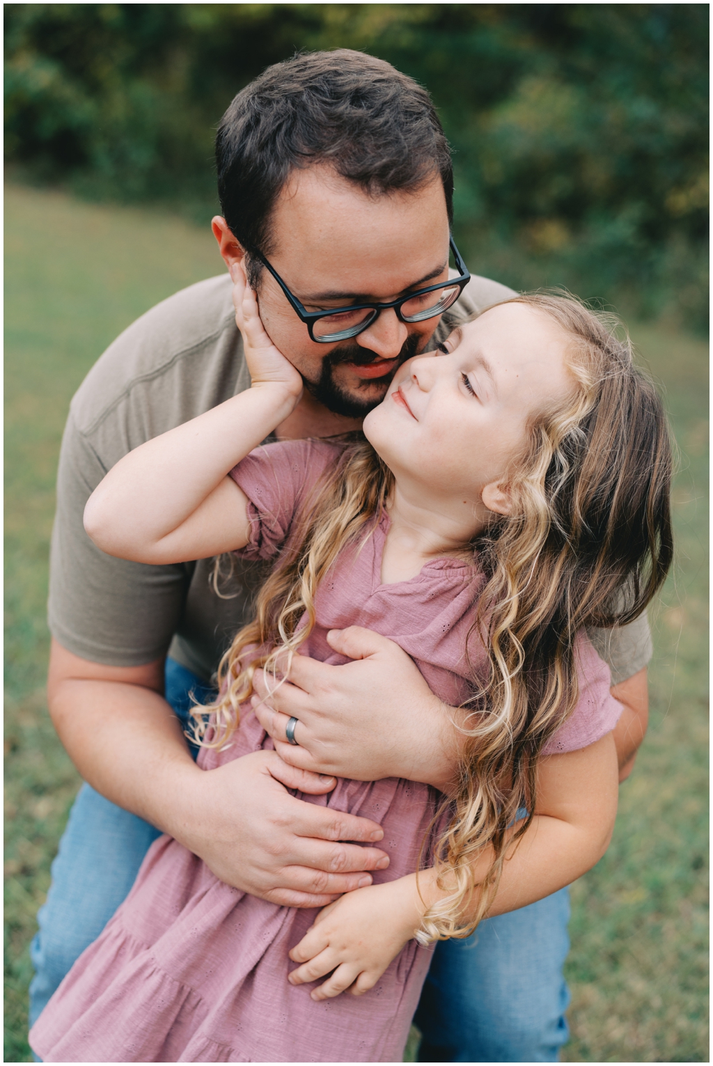 Dad and daughter playing together during laid back fall family session in Knoxville, TN. 