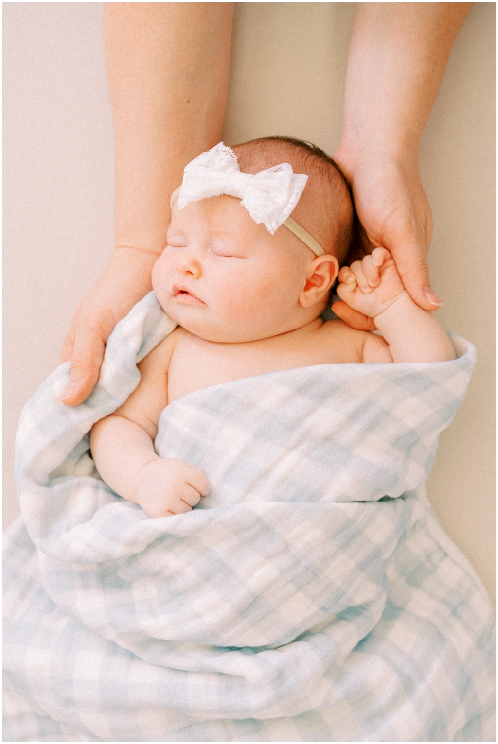 Newborn is held in parents hands during quaint and intimate newborn session in Knoxville, TN.