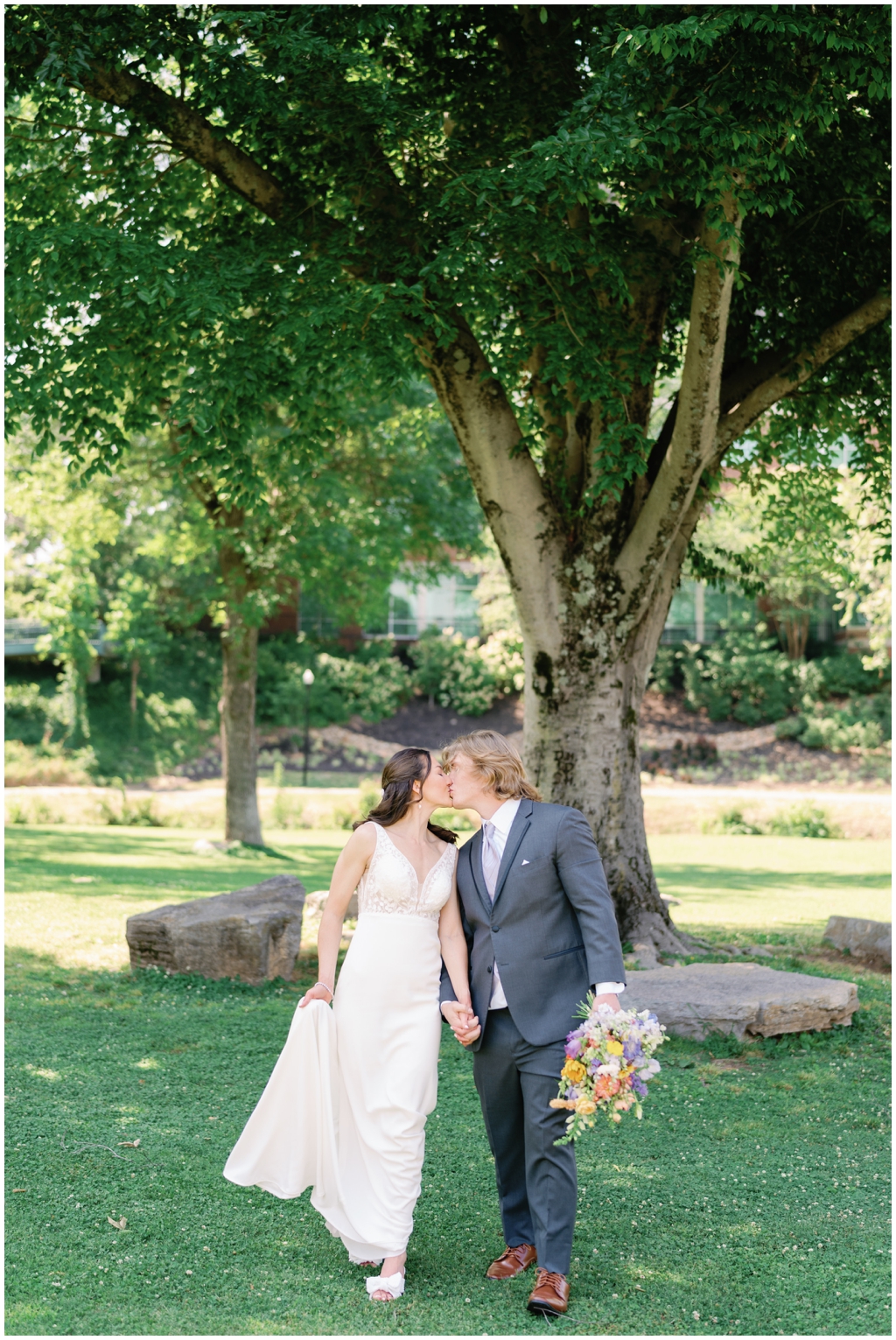 Bride and groom share a kiss in Maryville park after the reception. 