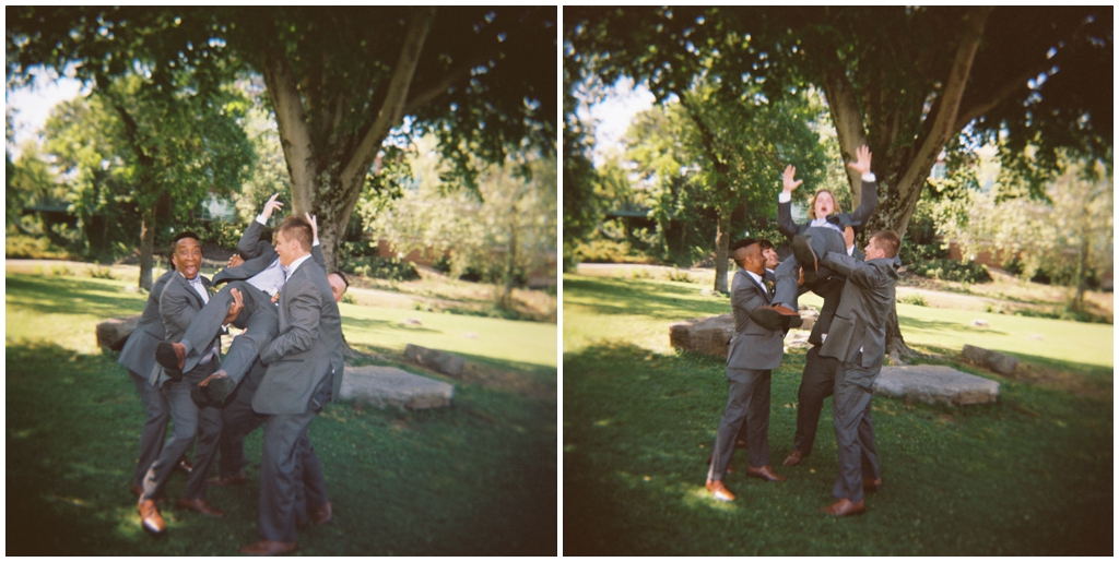 Groomsmen lift groom up into the air at Maryville park.