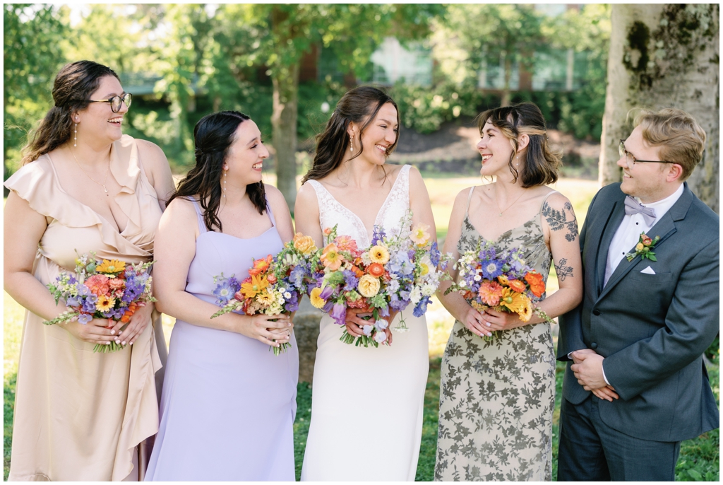 Bridal party smiles at bride in bright vibrant image taken at Maryville, TN.