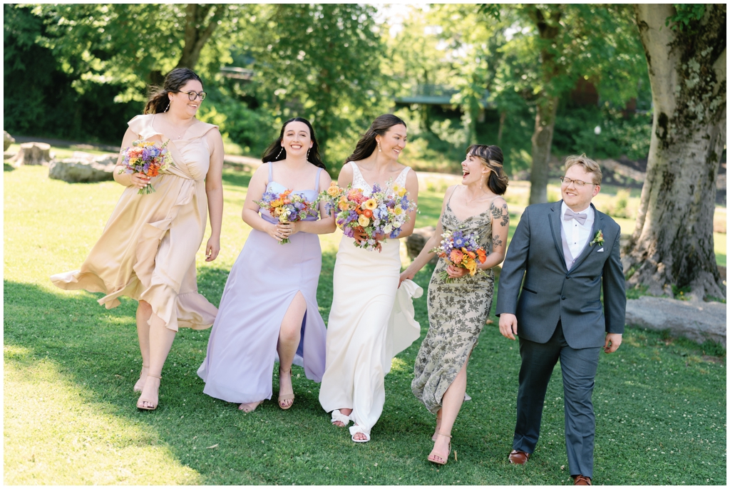 Bridal party walking together at Maryville park.