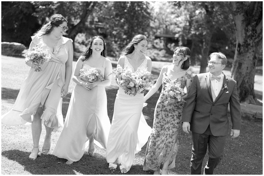 Black and white photo of bridal party walking together at Maryville park.