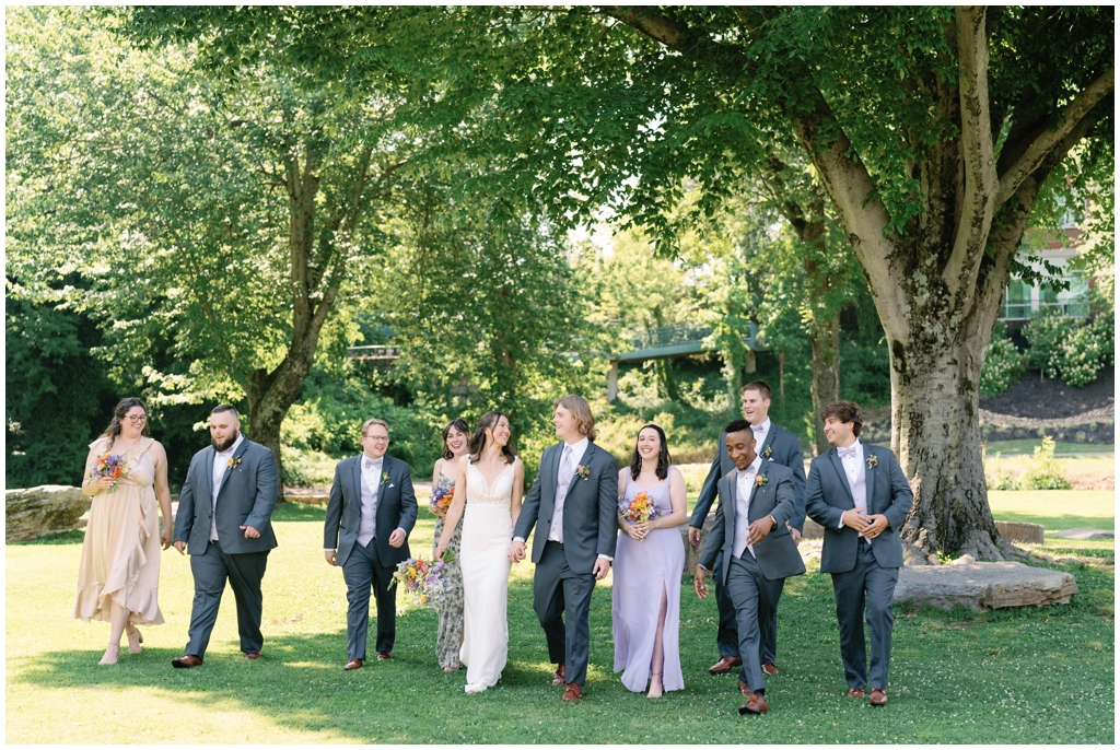 Wedding party strolls in park after reception of stunning Maryville wedding.