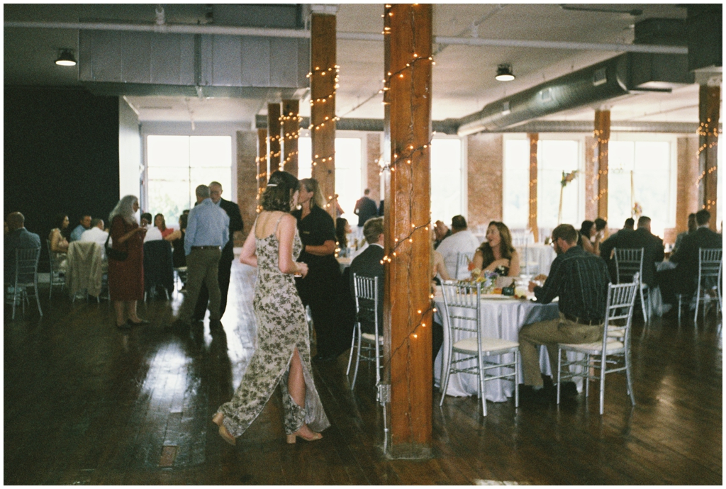 Film photo of wedding guests mingling during reception at Skyview venue in Maryville, TN.