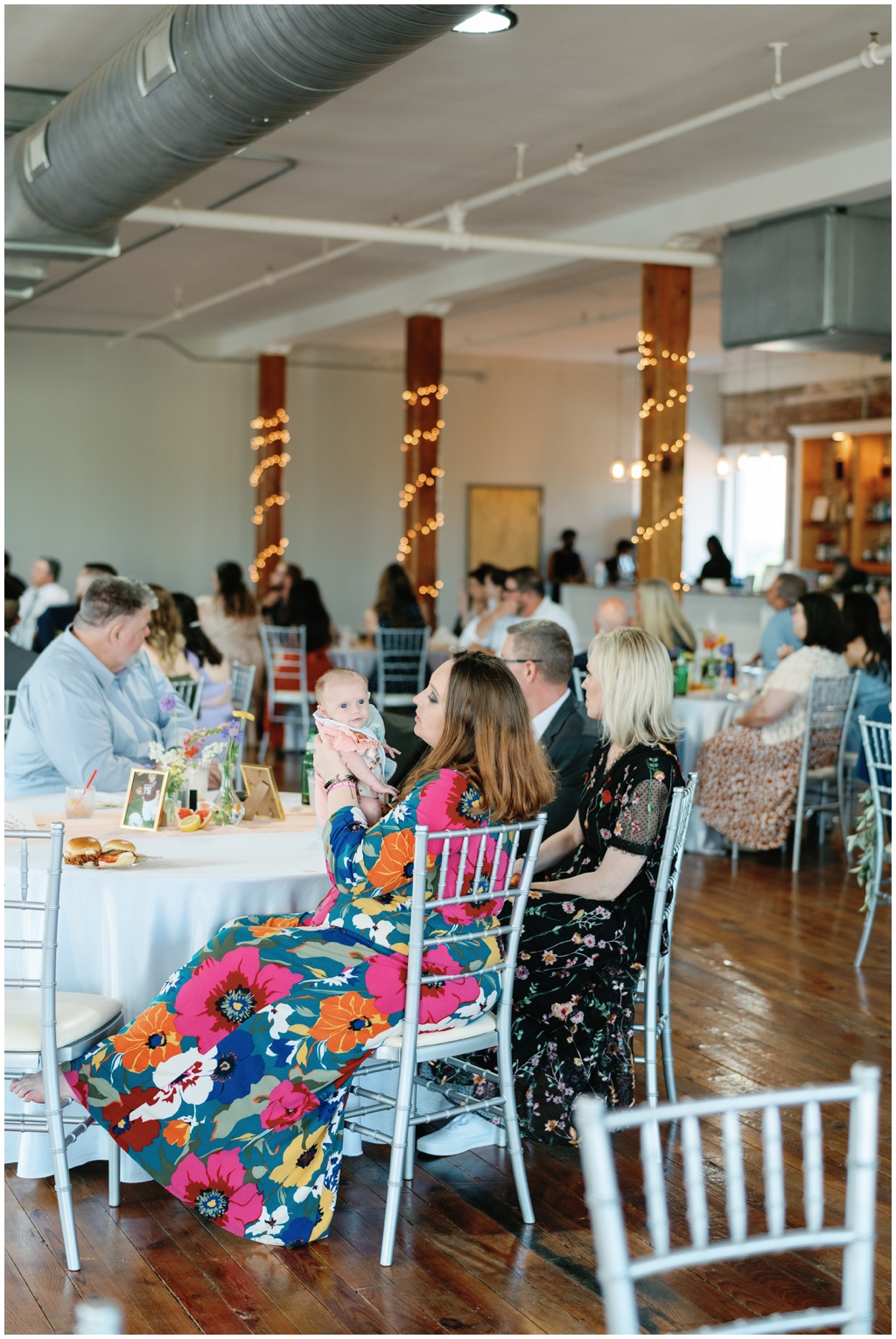 Wedding guests seated at reception for the bride and groom at Skyview venue.