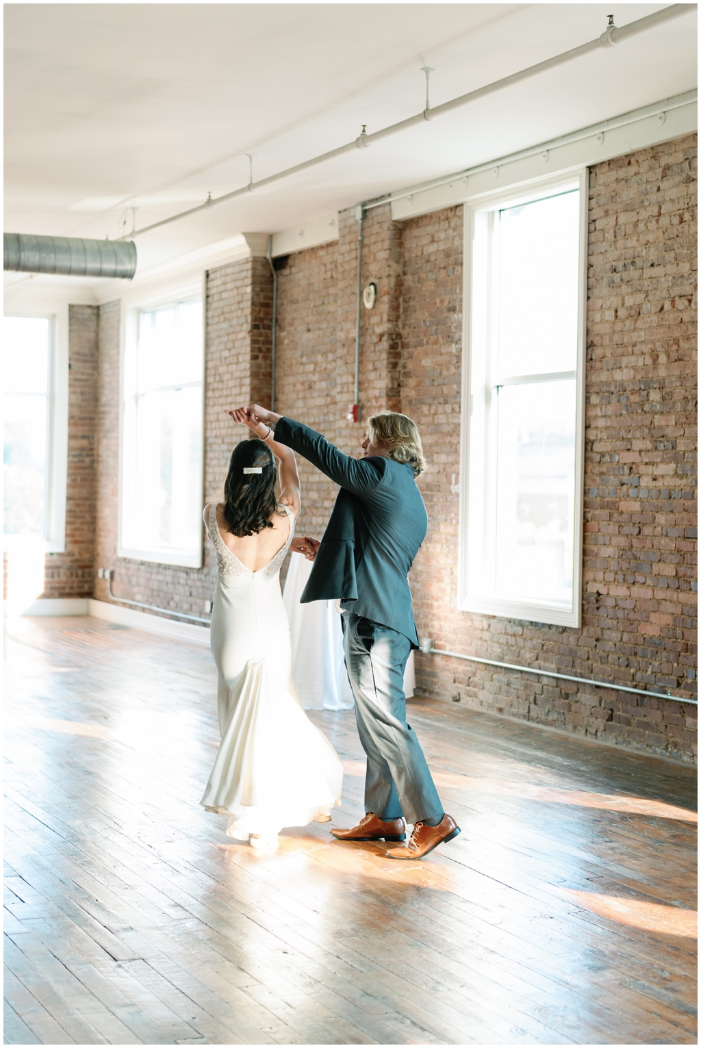 Groom twirls bride in first dance at Skyview venue in Maryville, TN.