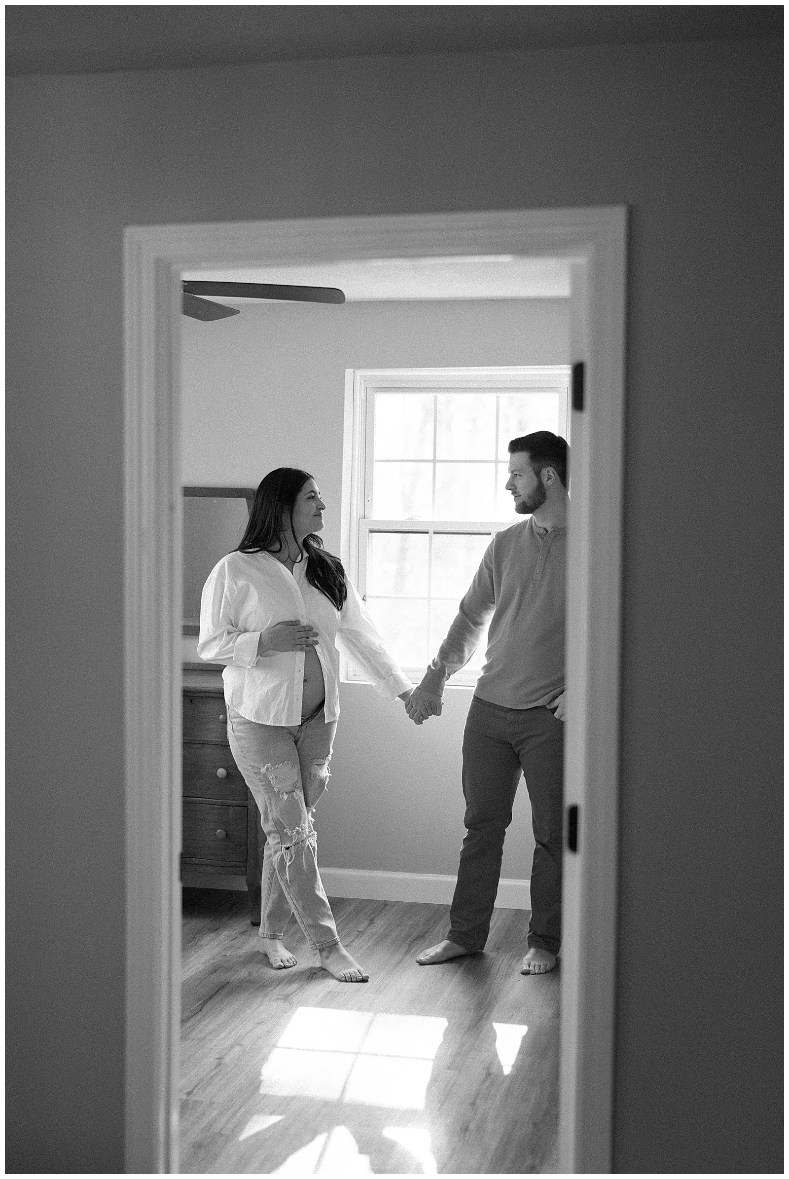 Black and white image of new parents during magical and timeless Knoxville maternity session.